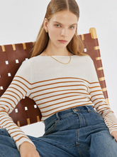 a lady in a wool striped boatneck slim sweater